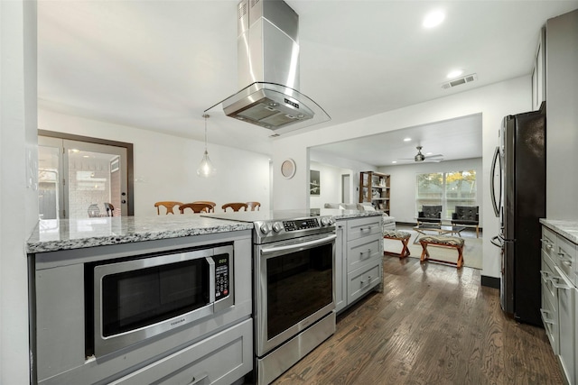 kitchen with island exhaust hood, light stone countertops, gray cabinetry, and stainless steel appliances