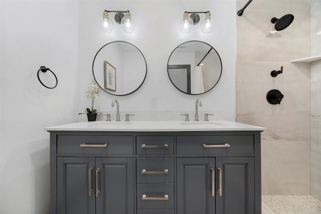 bathroom with vanity and tiled shower