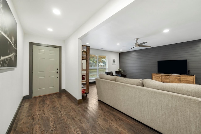 living room with ceiling fan and dark hardwood / wood-style flooring