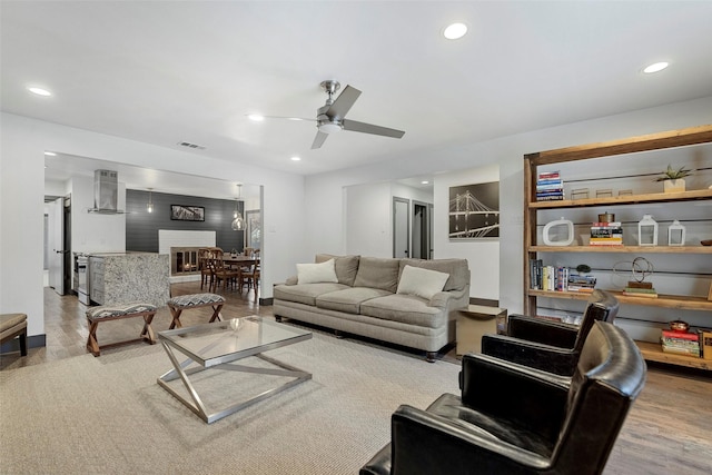 living room with ceiling fan and light hardwood / wood-style floors