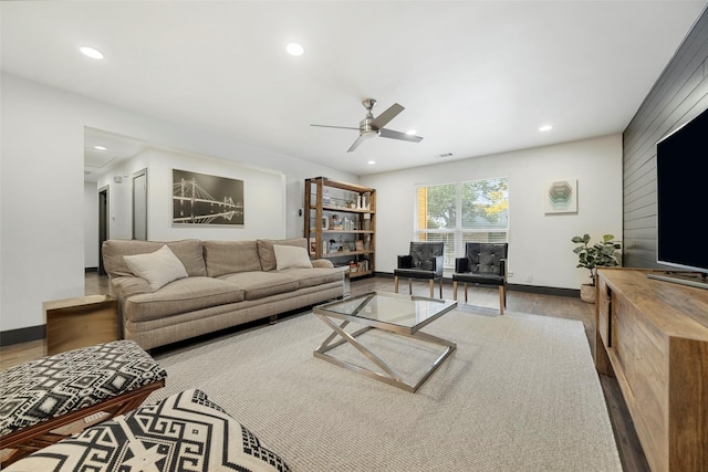 living room featuring light hardwood / wood-style floors and ceiling fan