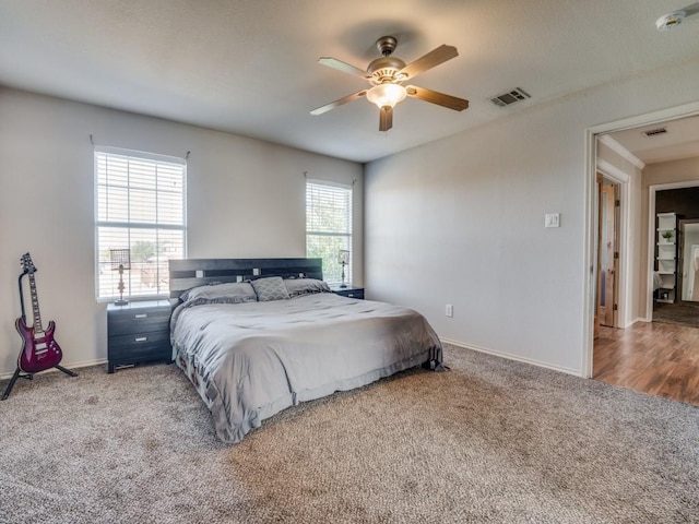 carpeted bedroom featuring ceiling fan and multiple windows