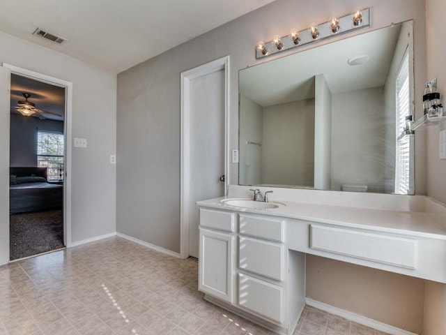 bathroom featuring vanity, ceiling fan, and toilet