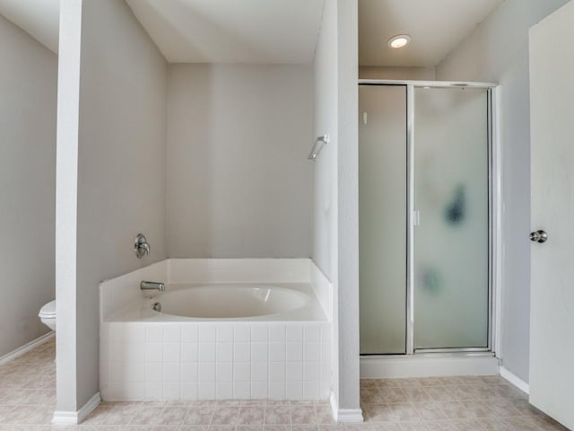 bathroom with shower with separate bathtub and toilet