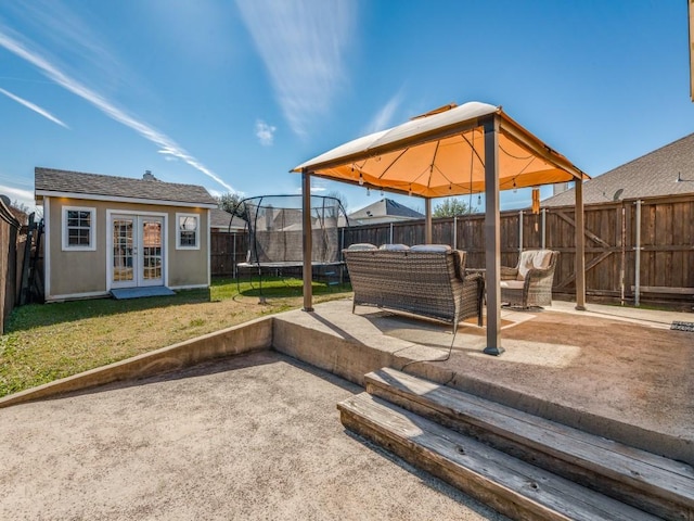 view of patio with a gazebo, an outdoor structure, and a trampoline