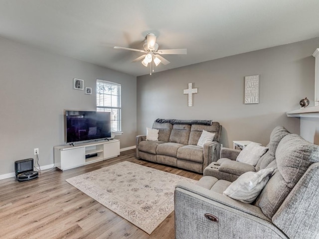 living room featuring hardwood / wood-style floors and ceiling fan