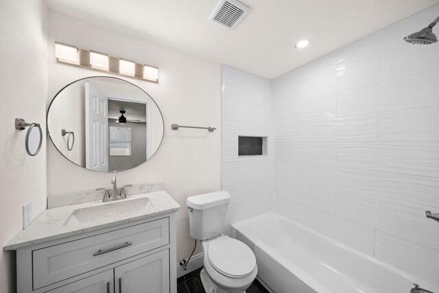 full bathroom featuring vanity, toilet, and tiled shower / bath