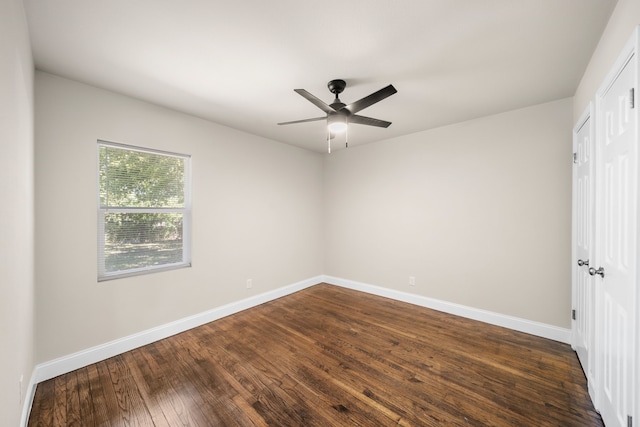 spare room with ceiling fan and dark hardwood / wood-style flooring