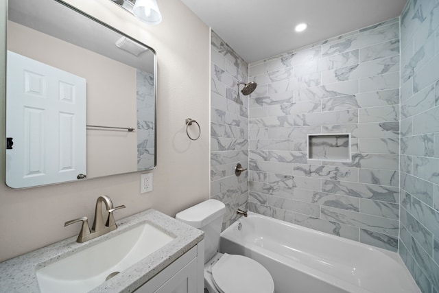 full bathroom featuring toilet, vanity, and tiled shower / bath