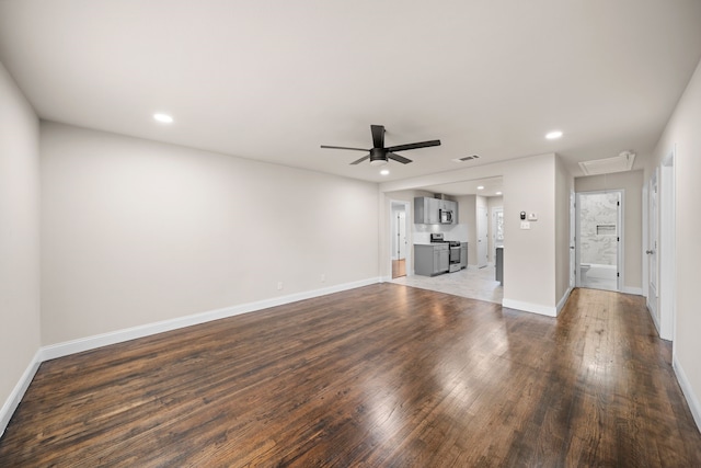 unfurnished living room featuring ceiling fan and dark hardwood / wood-style flooring