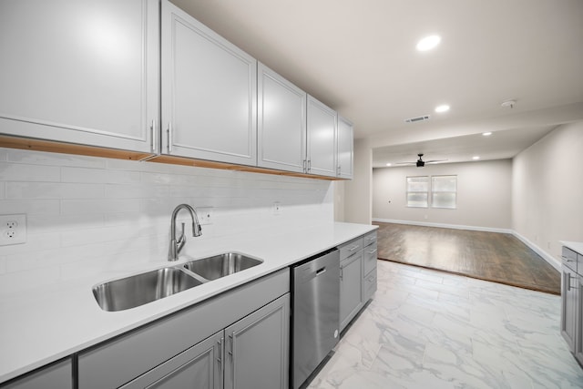 kitchen with sink, stainless steel dishwasher, ceiling fan, gray cabinets, and decorative backsplash