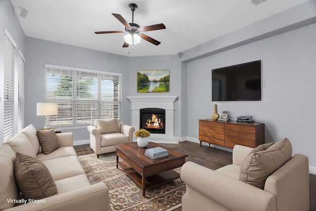 living room featuring hardwood / wood-style floors and ceiling fan