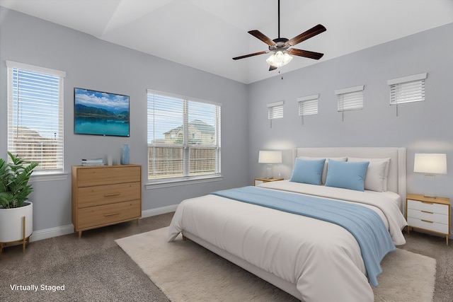 carpeted bedroom featuring vaulted ceiling and ceiling fan