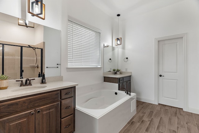 bathroom featuring vanity, plus walk in shower, and hardwood / wood-style floors