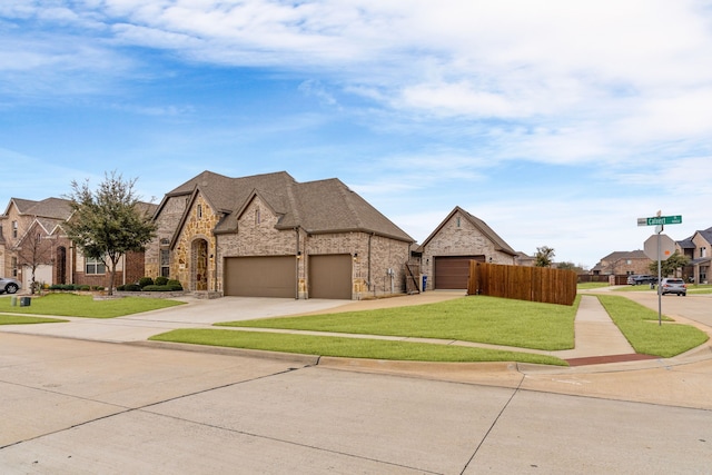 view of front of home with a garage and a front lawn