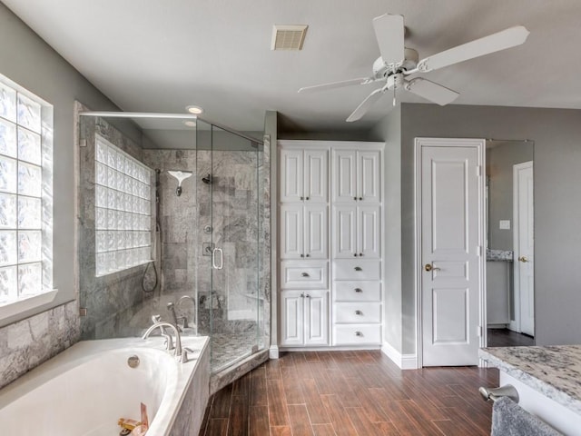 bathroom featuring ceiling fan, vanity, and independent shower and bath