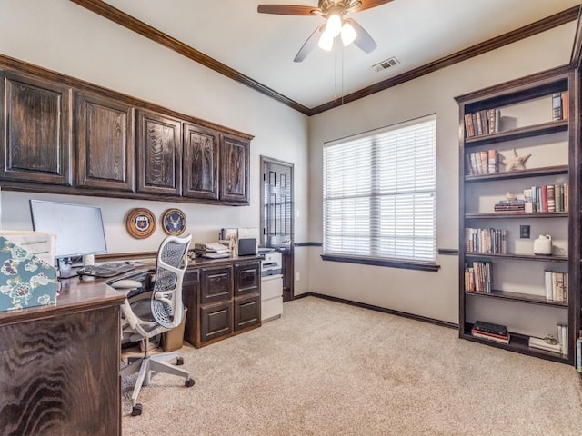 carpeted home office featuring ceiling fan and crown molding