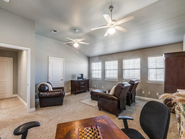 carpeted living room with ceiling fan and lofted ceiling