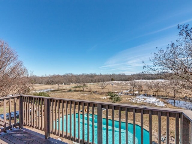 exterior space with a rural view and a fenced in pool