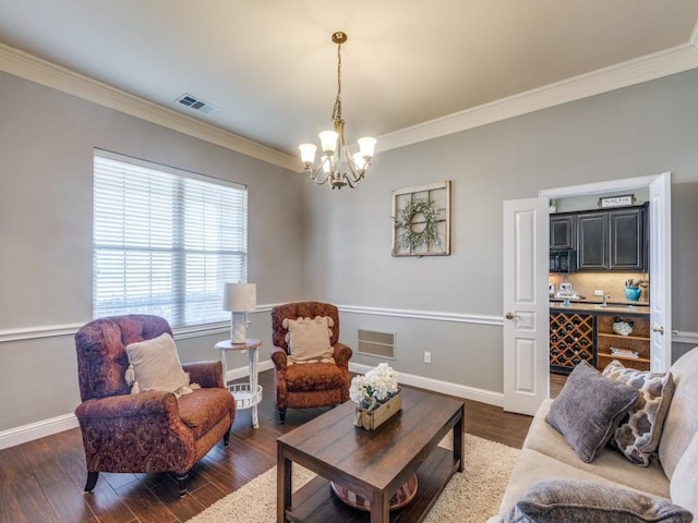 living room featuring crown molding, dark hardwood / wood-style floors, and a notable chandelier