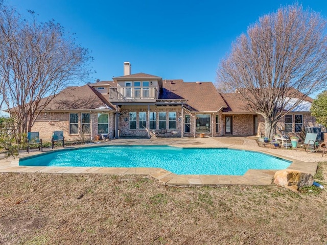 view of swimming pool featuring a lawn and a patio