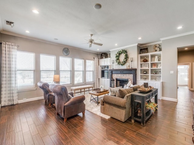 living room featuring ceiling fan, dark hardwood / wood-style flooring, ornamental molding, and a fireplace