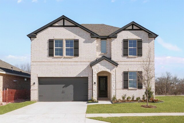 view of front facade with a garage and a front lawn