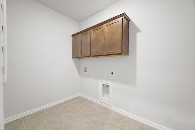 clothes washing area with cabinets, hookup for an electric dryer, and hookup for a washing machine