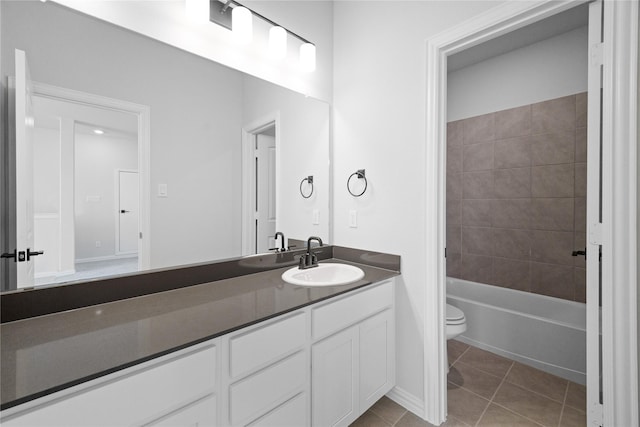 full bathroom with tiled shower / bath combo, vanity, tile patterned floors, and toilet