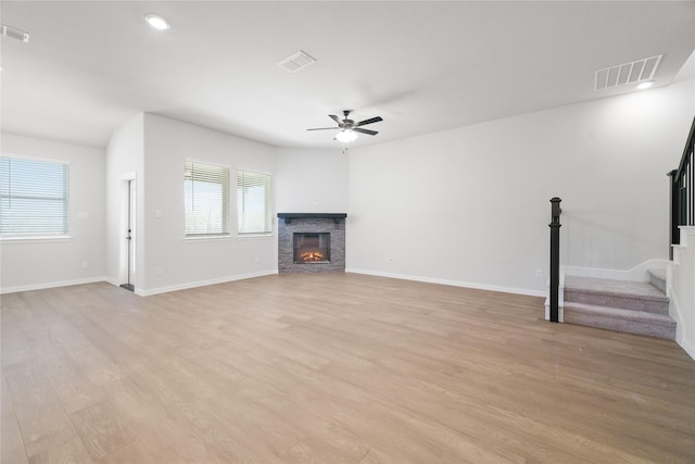 unfurnished living room with ceiling fan and light hardwood / wood-style flooring