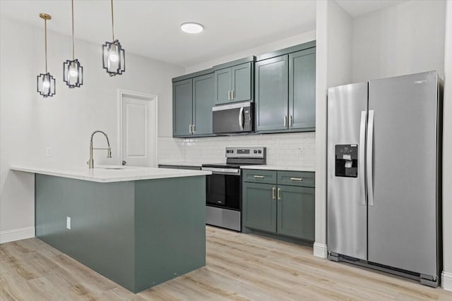 6305 Pebble Ave, Dallas, TX 75217 - kitchen with kitchen peninsula, stainless steel appliances, sink, decorative light fixtures, and light hardwood / wood-style flooring
