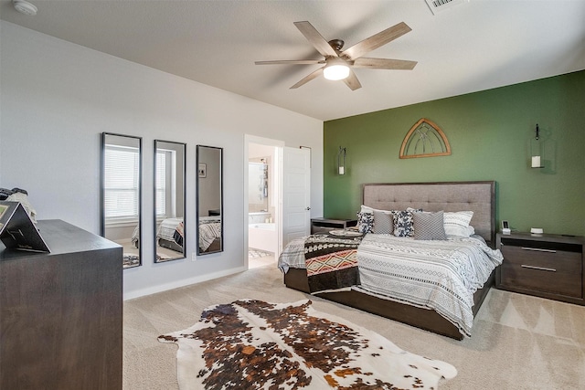 carpeted bedroom featuring ensuite bath and ceiling fan