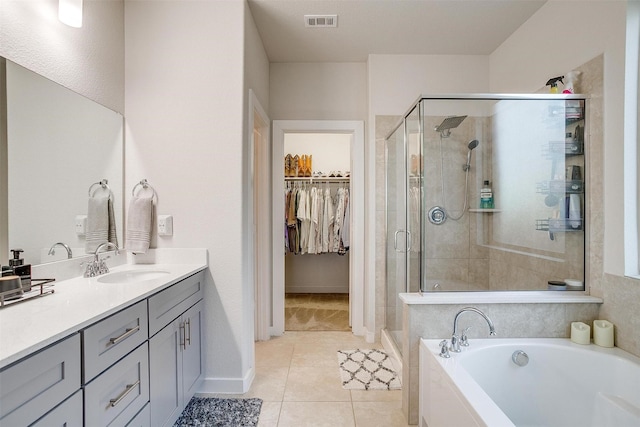 bathroom with separate shower and tub, tile patterned flooring, and vanity