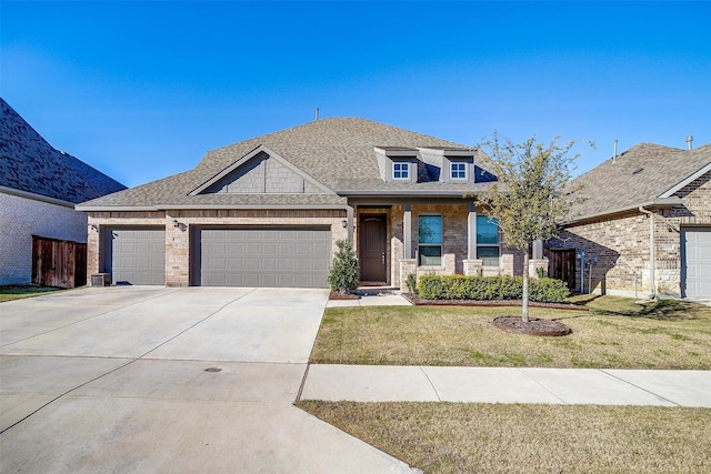 view of front of property with a garage and a front lawn