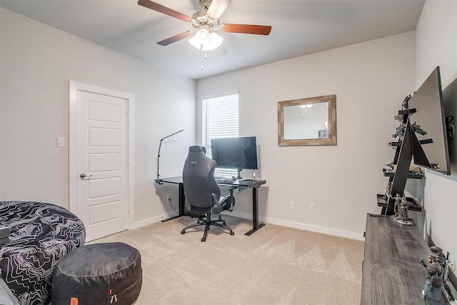 home office featuring light carpet and ceiling fan