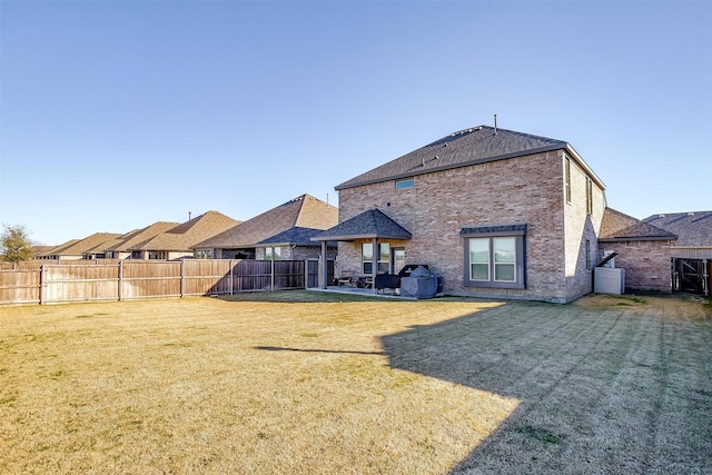 rear view of property featuring a yard