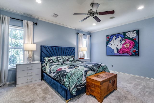 bedroom with multiple windows, light colored carpet, ceiling fan, and crown molding