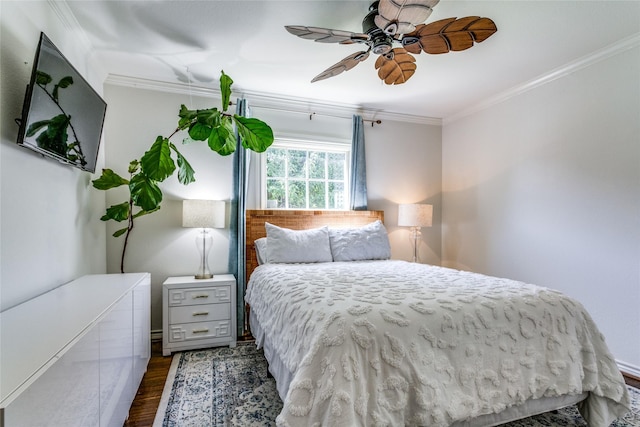 bedroom with ceiling fan, dark wood-type flooring, and ornamental molding