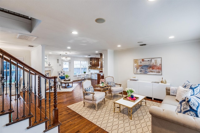 living room featuring light hardwood / wood-style floors and ornamental molding