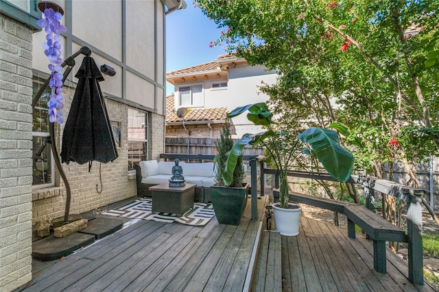 wooden deck with an outdoor living space