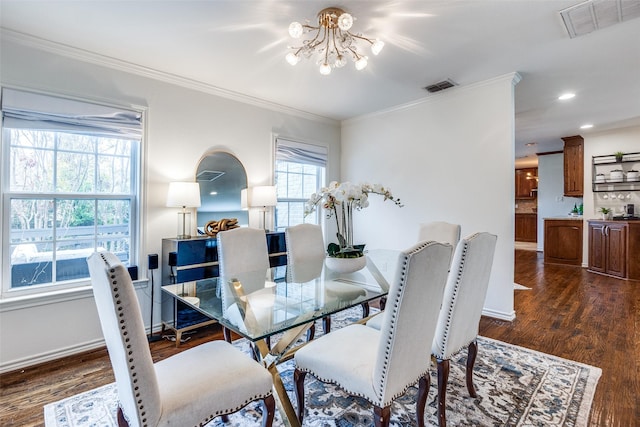 dining area featuring a chandelier, dark hardwood / wood-style flooring, and ornamental molding