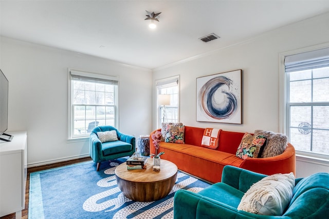 living room with hardwood / wood-style flooring and crown molding