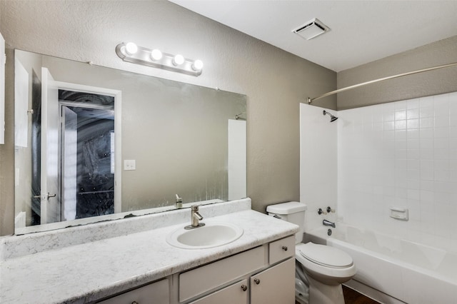 full bathroom featuring vanity, toilet, and tiled shower / bath