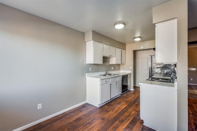 kitchen featuring dishwasher, white cabinets, sink, dark hardwood / wood-style flooring, and range