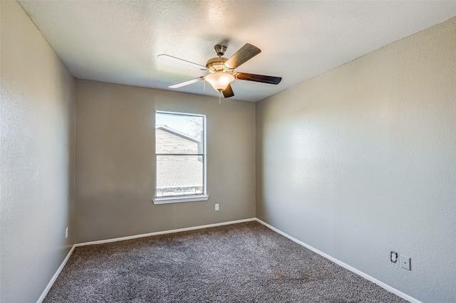 carpeted empty room featuring ceiling fan and a textured ceiling