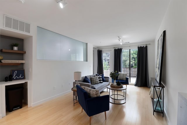 living room with light hardwood / wood-style flooring