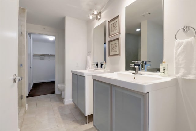 bathroom with tile patterned floors, vanity, and toilet