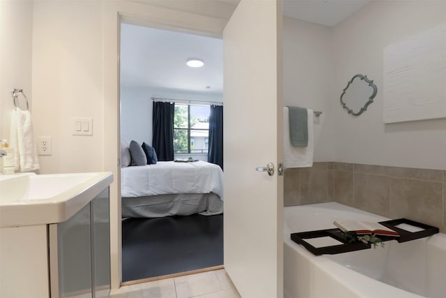 bathroom with tile patterned flooring, vanity, and a tub to relax in