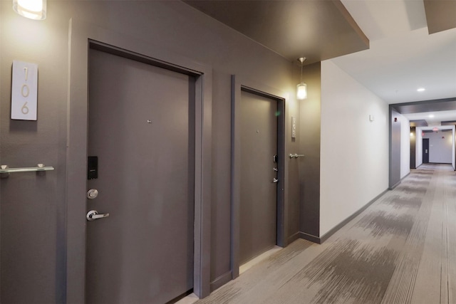 hallway featuring light colored carpet