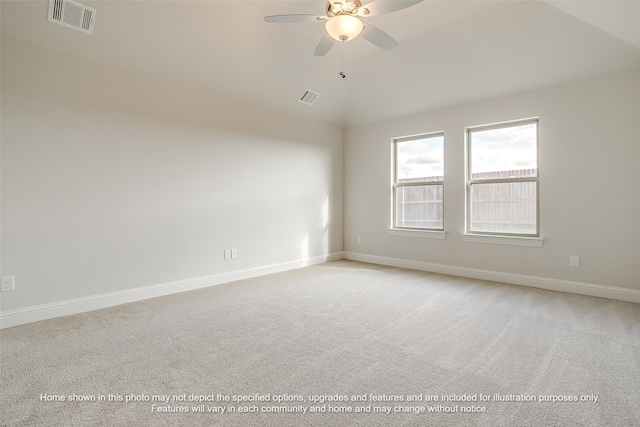 empty room with lofted ceiling, visible vents, and light colored carpet